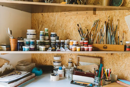 Artistic workspace with paints and canvases